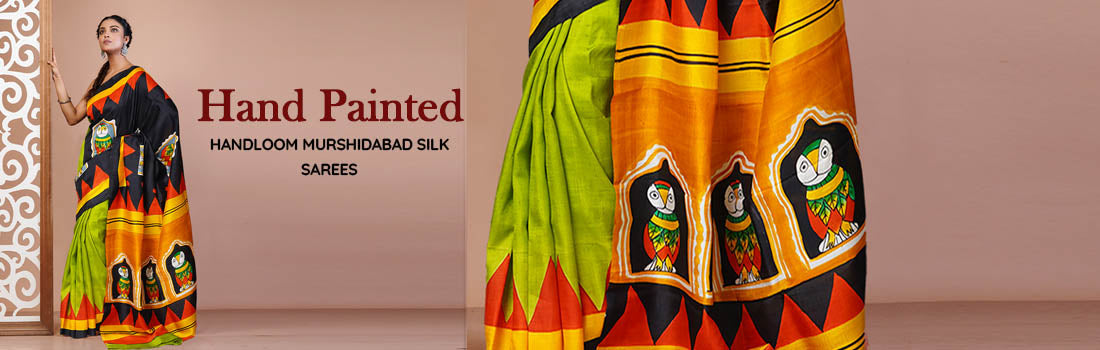 Elegant woman wearing a traditional Hand Painted Saree with intricate artistic motifs and vibrant colors